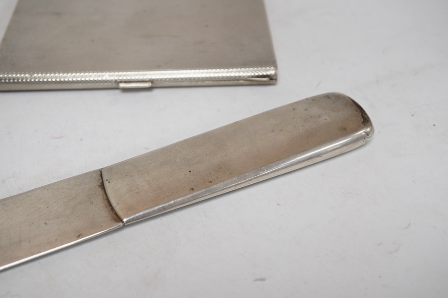 An engine turned 800 standard white metal cigarette case, 12cm, a 1920's Russian 875 standard white metal cigarette case and a white metal paper knife or page turner.